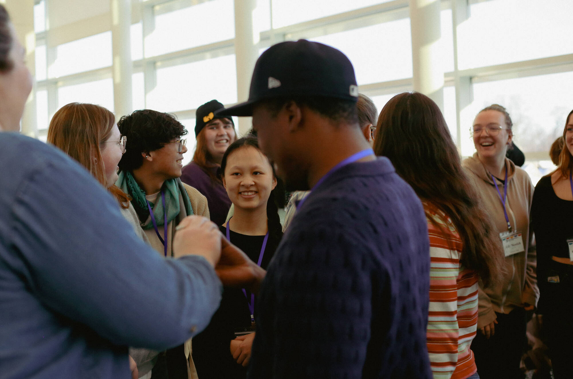 Students in a group laughing and smiling at each other